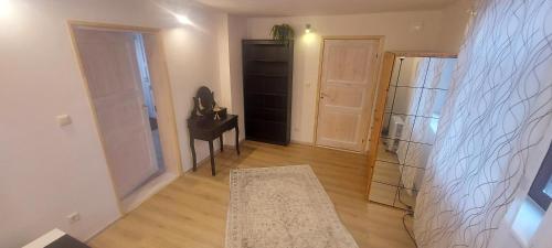 a living room with a piano and a black closet at Marja Apartment in Tartu