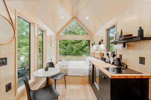 a tiny house with a kitchen and a bedroom at Lumen Nature Retreat in Woodstock