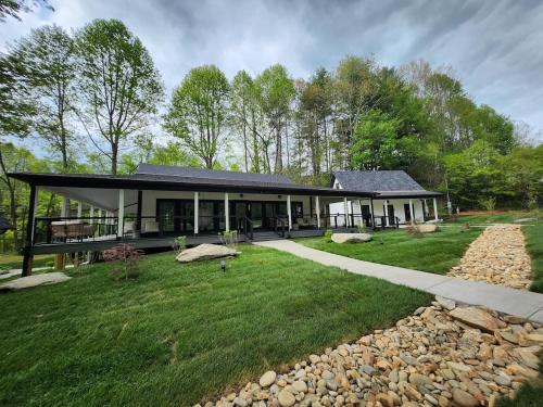 a house with a large yard with a house at Life's Good Retreat Main House in Brevard