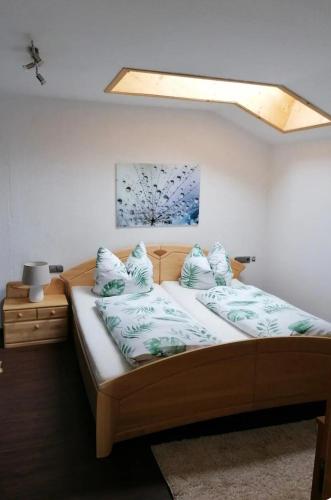 a bedroom with two beds with blue pillows at Ferienwohnung Fleur in Bad Kohlgrub