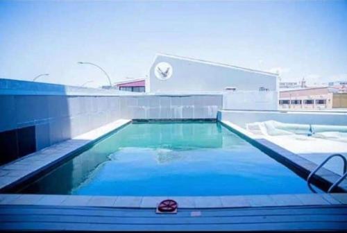 a swimming pool with blue water in a building at Serenity at 77 Independence Avenue, Windhoek CBD in Windhoek