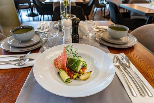 a table with a plate of food on a table at Hotel Fero Express POKOJE KLIMATYZOWANE AC in Kraków