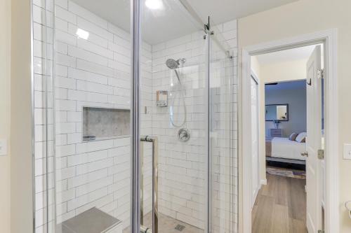 a white bathroom with a shower with a glass door at Wichita Townhome with Patio 9 Mi to Downtown! in Wichita