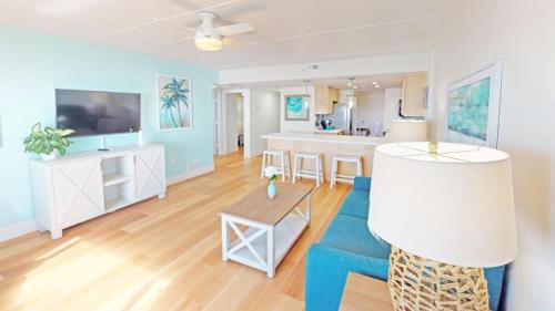 a living room with a couch and a table at Princess Royale Oceanfront Resort in Ocean City