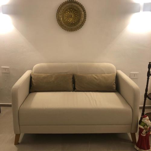 a white couch in a living room with two lights at Netium B&B in Andria