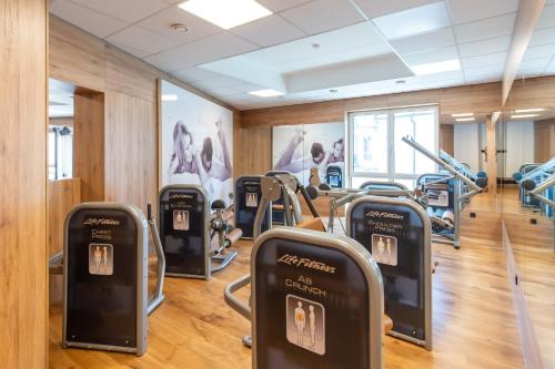 a gym with several cardio machines in a room at Hotel-Restaurant Heiligenstadter Hof in Heiligenstadt