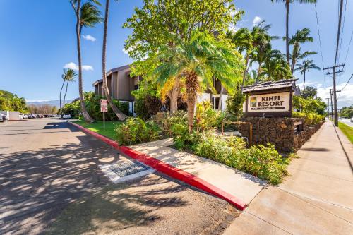 a street with a hotel sign and palm trees at Your Maui Getaway-Walk to the Beach, Pool, Hot Tub LSV14 in Kihei