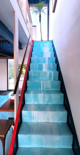 a staircase in a house with blue and red stairs at Kaze no iro Bijutsukan - Vacation STAY 29975v in Asahi