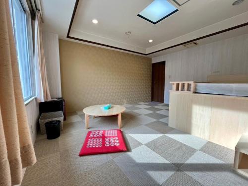 a room with a bed and a red rug on the floor at Yuzawa house 2 - Vacation STAY 39908v in Yuzawa