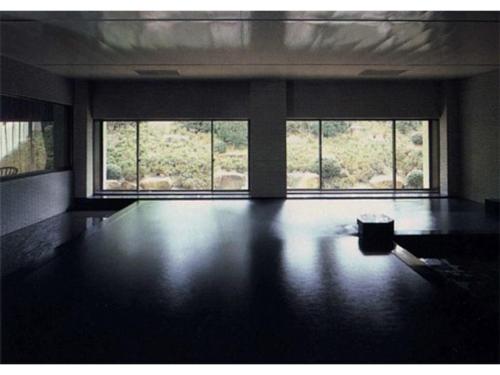 an empty room with two large windows and a table at Hotel Kaishunro - Vacation STAY 54369v in Hamamatsu