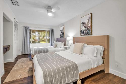 a bedroom with two beds and a window at Golden Retreat: Expansive 6BR Home w Heated POOL ~ in Seminole