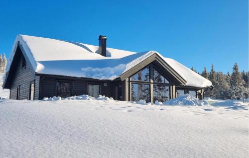 a house covered in snow in the snow at Lovely Home In Lillehammer With Kitchen in Lillehammer
