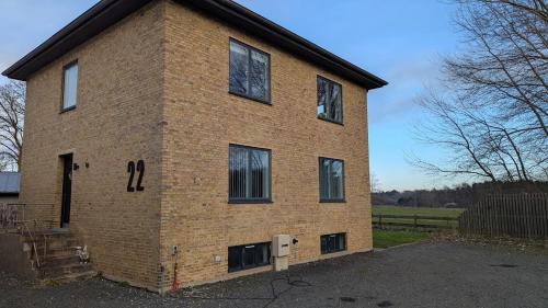 a brick building with four windows on the side of it at Sleep In Lynge in Lynge