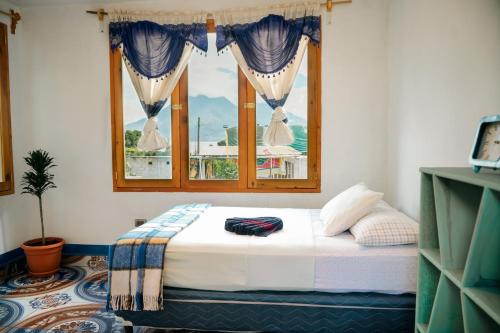 a bed in a room with a window at Casa Madera in San Marcos La Laguna