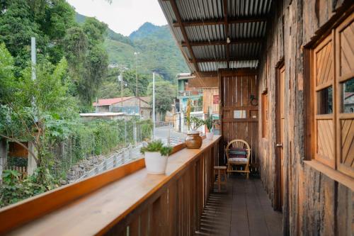 an outdoor balcony with a view of a street at Casa Madera in San Marcos La Laguna