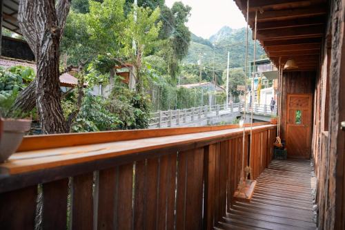 a wooden balcony with a view of a tree at Casa Madera in San Marcos La Laguna