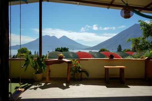 a balcony with a table and a view of the mountains at Casa Madera in San Marcos La Laguna