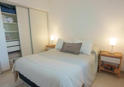 a small bedroom with a bed with a pillow on it at Departamento 2 Premium con Cochera y Piscina in Bahía Blanca