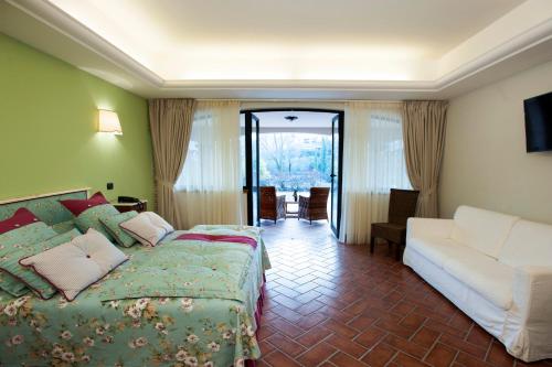 Habitación de hotel con cama y sofá en La Vignola Country Hotel en Ceprano
