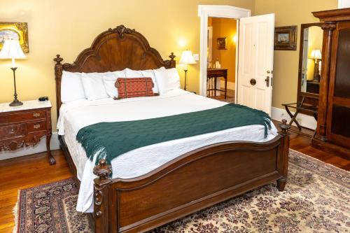 a bedroom with a large bed and a rug at Eliza Thompson House, Historic Inns of Savannah Collection in Savannah