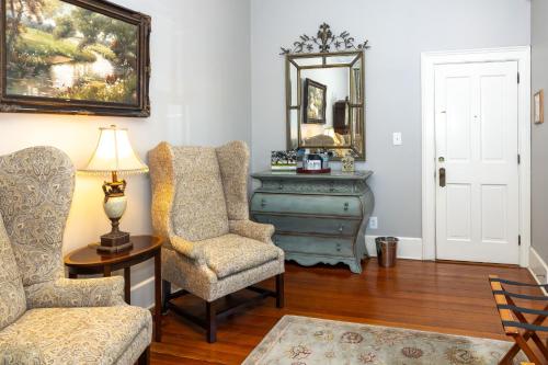 a living room with a chair and a dresser at Eliza Thompson House, Historic Inns of Savannah Collection in Savannah
