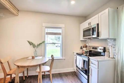 a kitchen with a table and a small table and a table and chairs at Cheerful 3 bedroom Villa with Backyard Oasis in Spokane