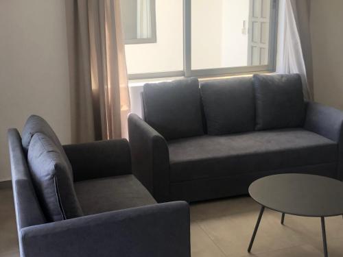 a living room with a couch and a table at Canonniers Luxury Stay in Pointe aux Cannoniers