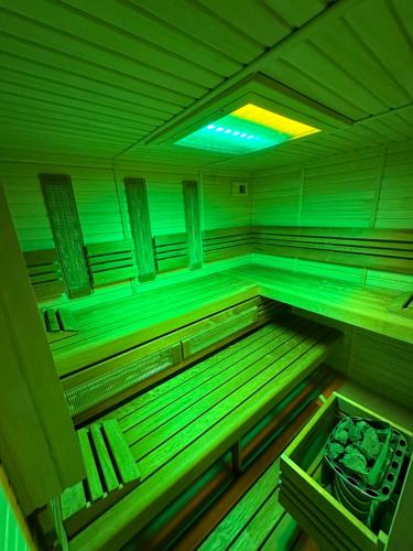 a large empty sauna with green lights in it at Penzion Lukeš in Vítkovice