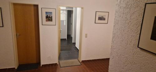 a hallway with a mirror and a tile floor at Panorama Eifel View in Nideggen