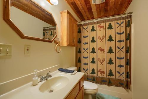 a bathroom with a sink and a toilet and a shower curtain at Navajo in Logan