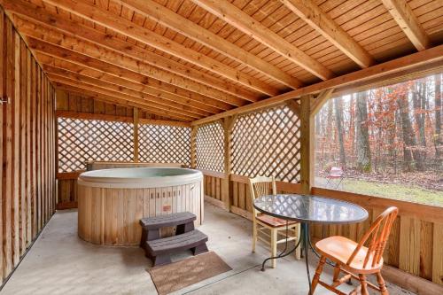 a porch of a wooden cabin with a table and a sauna at Navajo in Logan