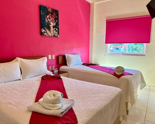 Postel nebo postele na pokoji v ubytování Hotel Barranquilla