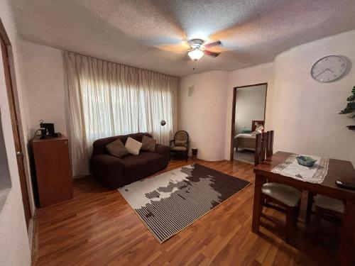 a living room with a couch and a table at Suite Progreso in Mexico City