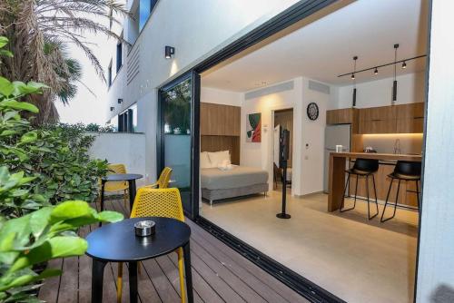 a house with a balcony with a bedroom at Luxury Garden Studio Apartment 2 in Tel Aviv
