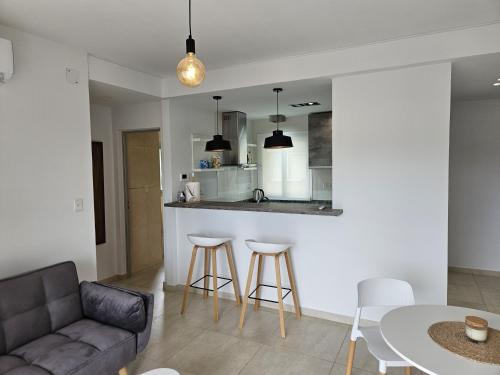 a living room with a couch and a table at Departamento de Lujo sobre Costanera in Posadas