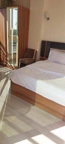 a bedroom with a bed and a chair and a window at Hurghada Mirage Bay Hotel & Aquapark in Hurghada