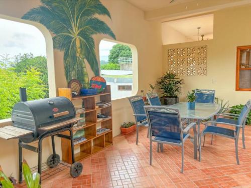 a dining room with a table and chairs and a grill at St. Francis Suite in San Juan del Sur