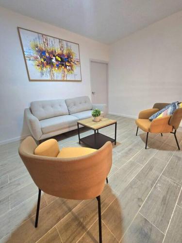 a living room with a couch and two chairs at Penthouse Moderno, playa privada in Punta Cana