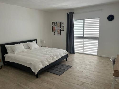 a bedroom with a bed and a large window at Penthouse Moderno, playa privada in Punta Cana