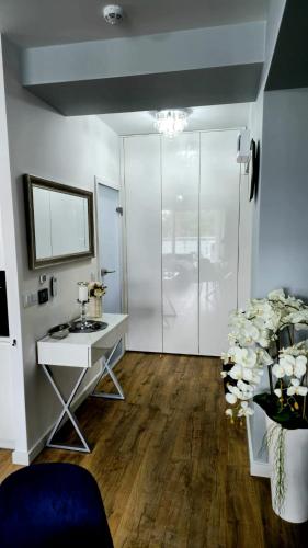 a room with a desk and a glass door at Crystal Baltic 222 in Dziwnówek