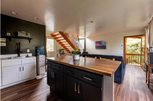 a kitchen with a wooden counter top in a room at Caldera- Hale Kumu La'au at Volcano in Volcano