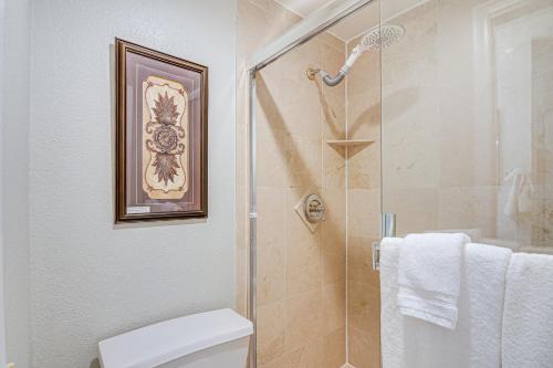 a bathroom with a shower with a toilet and towels at Hike, Bike and Fish Brian Head Resort Condo! in Brian Head