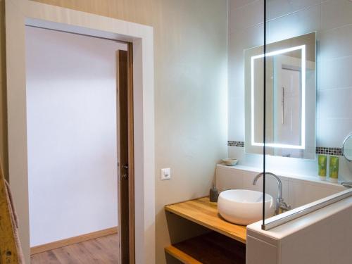 a bathroom with a sink and a mirror at La Commanderie in Cossonay