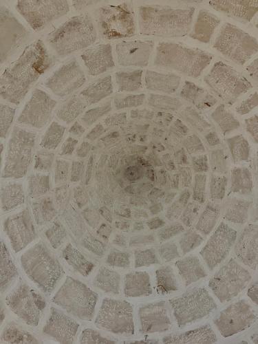 a ceiling of a building with a stone design at Trulli Milena in Putignano