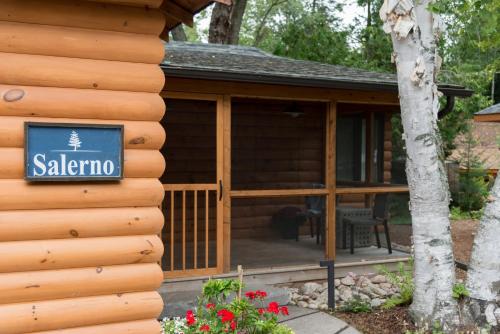 a log cabin with a screened in porch at Haliburton Post House in Minden