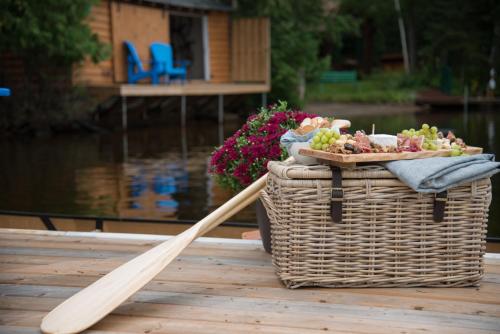 a wooden paddle next to a basket and a basket of food at Haliburton Post House in Minden