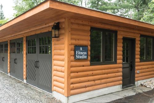 a wooden cabin with a sign that reads fitness studio at Haliburton Post House in Minden