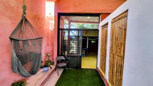 a porch with a hammock hanging from a house at Casa Rosa in Sayulita