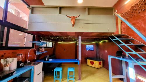 a room with a loft with a cow head on the wall at Casa Rosa in Sayulita