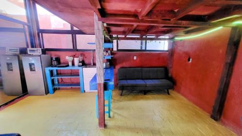 a room with a couch in the middle of a room at Casa Rosa in Sayulita